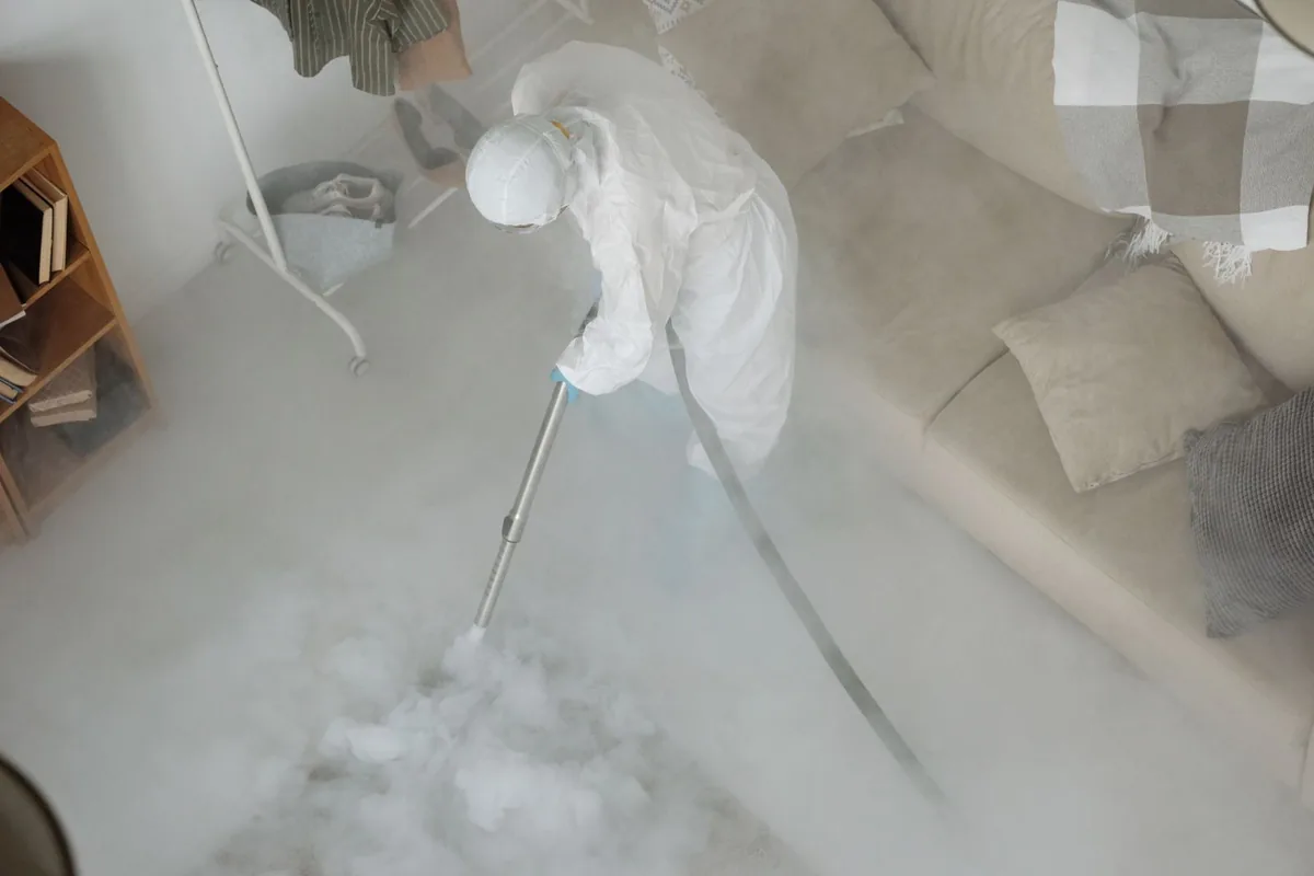Biohazard cleanup technician in protective equipment, Highland, CA
